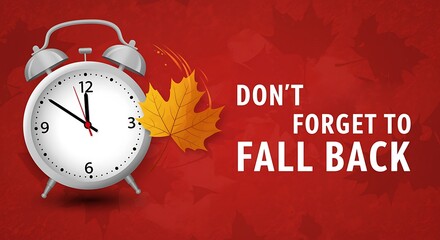 Alarm clock with autumn leaves and text dont forget to fall back on red background