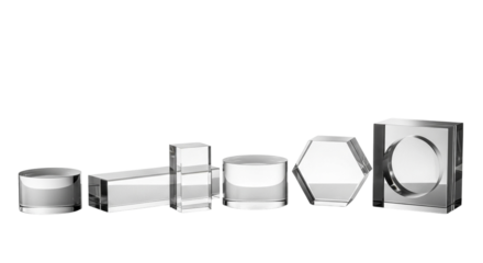 Collection of geometric transparent acrylic blocks in various shapes, isolated on a transparent background