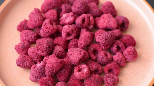 Dried sublimated slices of raspberry as an ingredient for sweet desserts. Dried raspberry as a food background for your design