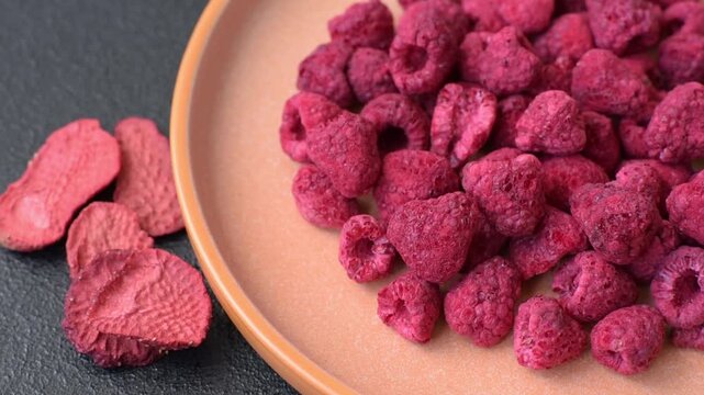 Dried sublimated slices of raspberry as an ingredient for sweet desserts. Dried raspberry as a food background for your design
