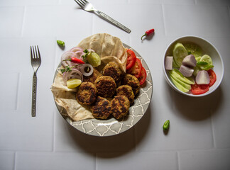 Galouti kebab or melt in the mouth kebab served paratha or flat bread. Famous Awadhi dish of Lucknow, India.