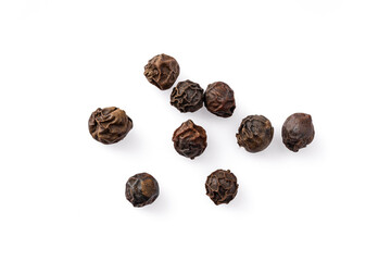 Black peppercorns on white background