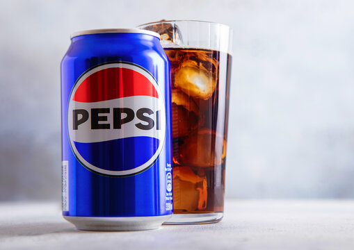 LONDON,UK - AUGUST 21, 2025: Pepsi Cola Original soda soft drink with glass with ice cubes on light table background.