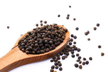 Black peppercorns on white background	
