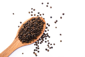 Black peppercorns on white background	