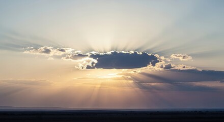 Sunlight breaking through clouds during sunset sky