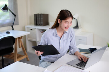 A young female employee is intently checking documents.