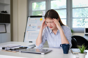 Young female employee is stressed from overwork.