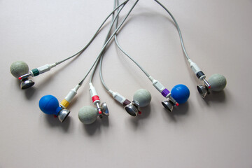 On the table is a suction cup for an electrocardiograph. On a gray background.