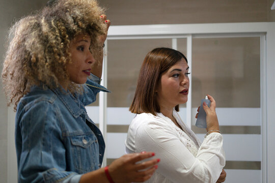 Women friends doing beauty grooming routine in bathroom - Powered by Adobe