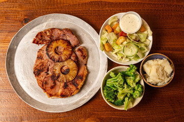 Virginia ham steak with salad and side dishes