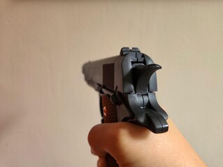 Fake Gun in Action with Hand Holding. Though just an airsoft replica, the photo showcases the...