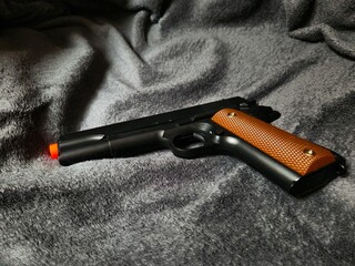 Toy Gun with Wooden Details. Though just an airsoft replica, the photo showcases the weapon's...