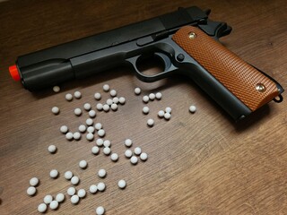 Airsoft gun with white pellets. Though just an airsoft replica, the photo showcases the weapon's...