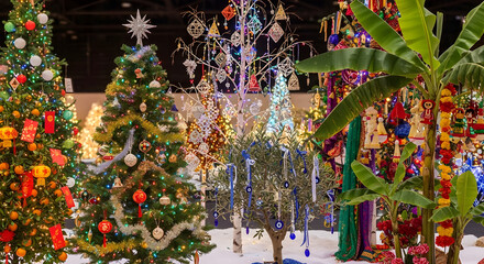 A vibrant colorful Christmas tree blazes with lights and ornaments in the city at night, marking the joyous holiday season and celebration