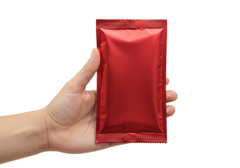 Fresh red condiment packet held by a hand isolated on white, perfect for food service or product mockups