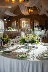 Elegant wedding banquet hall features a beautifully arranged table with floral centerpiece, soft lighting, and a romantic atmosphere for celebrations