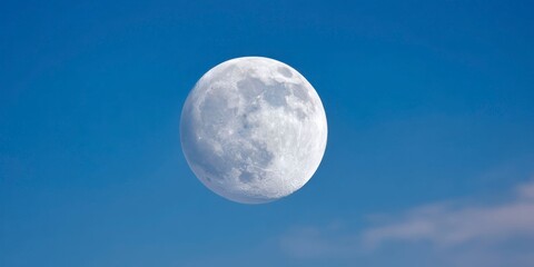 a full moon in the night sky, clear blue sky