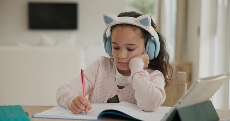 Homeschooling, tablet and child in house with headphones for elearning, project or assignment. Online education, digital technology and girl kid writing in notebook for math assessment in apartment.