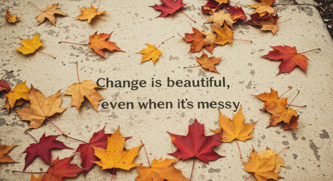 Autumn leaves scattered on concrete background with inspirational quote  