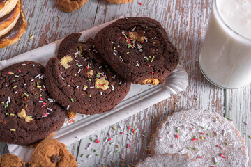 A delightful assortment of cookies and milk with colorful sprinkles on a rustic wooden background, perfect for National Cookie Day celebrations