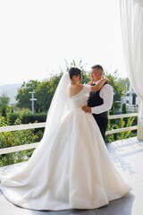 Couple shares a tender moment during their wedding ceremony in a beautiful outdoor setting