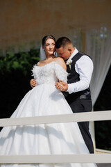 Couple shares a romantic moment during their wedding at an outdoor venue