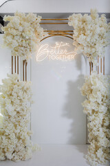 Elegant floral archway decoration for celebration with neon sign