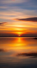 Fototapeta premium Golden Hour Reflection - Serene Sunset Over Calm Waters.