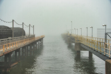 Twin Piers Vanishing into Heavy Sea Fog