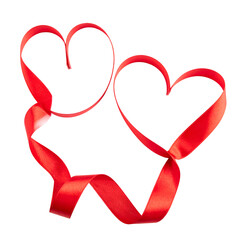 Two intertwining red ribbon hearts isolated on black background, celebrating love and affection