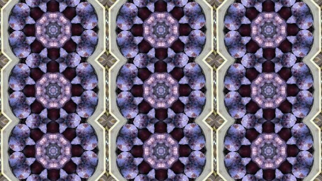 A repeating kaleidoscopic pattern featuring floral motifs in shades of purple and gold