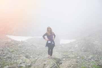 Naklejka premium A young girl watches the crater lake and mountains in the high altitude Kaçkar plateaus..