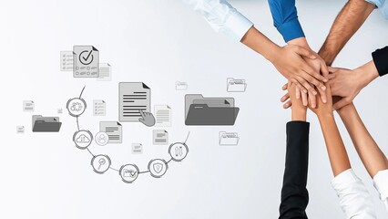 This image showcases a diverse team collaborating on project management with hands joined over documents and organizational icons, symbolizing teamwork and productivity. Raster
