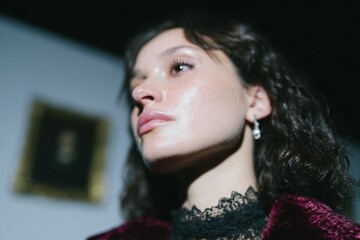 Portrait of a Young Woman with Curly Hair in Dramatic Lighting
