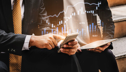 Business professionals engaged in financial analysis using a smartphone and tablet, surrounded by...