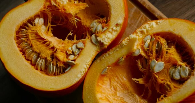 Juicy close-up of a freshly cut pumpkin showing vibrant orange flesh and detailed texture. Perfect for autumn themes, healthy food, and seasonal vegetable concepts.