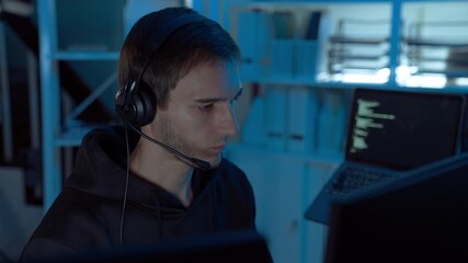 IT support specialist wearing headset assisting remote clients in dark office, representing communication, reliability, and expertise in modern digital service and technology support. - Powered by Adobe