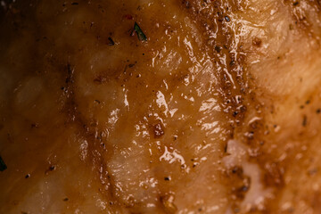 Close-up of Golden Roasted Chicken Skin with Herbs and Chili