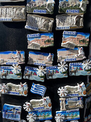 Colorful souvenir magnets from Athens, Greece, featuring famous landmarks such as the Parthenon, Acropolis, Greek flag, and Santorini scenery. A bright collection symbolizing Greek culture and tourism