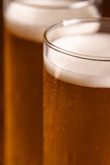Extreme Close-up of Cold Golden Beer Foam and Condensation
