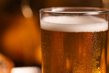 Extreme Close-up of Cold Golden Beer Foam and Condensation