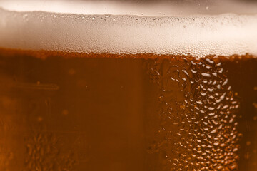 Extreme Close-up of Cold Golden Beer Foam and Condensation