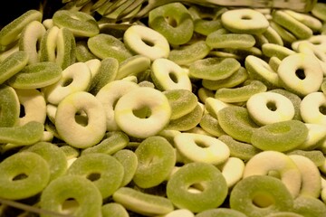Green round jelly beans sold in a candy store, close-up. Green round jelly beans for children. Fun jelly beans for Christmas, birthdays, and holidays. Junk food. Sugary foods. Food industry.
