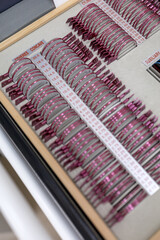Close-up of a trial lens set used for eye exams in optometry, showing various corrective lenses in...