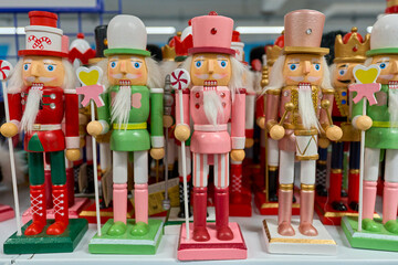 Colorful wooden nutcracker figurines in festive outfits on display. Traditional Christmas decorations symbolizing holiday cheer and craftsmanship.