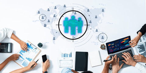 A collaborative business environment showing teams analyzing market trends using digital tools and visual data. Emphasizes strategic planning and teamwork. Trope