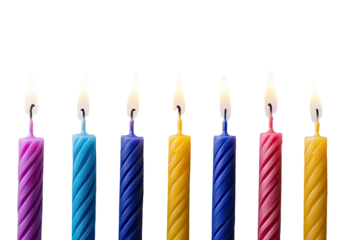 Seven spiral candles lit with bright flames against stark black background