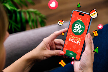Christmas sale. Woman with a mobile phone and a sale advertisement and many emojis around it....