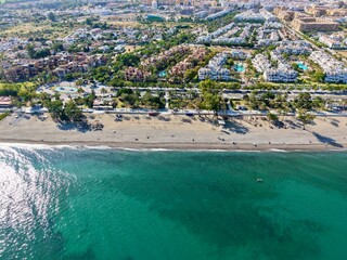 aerial view of the beach and promenade with palms in San Pedro de Alc&aacute;ntara in beautiful light, Malaga, Costa del Sol, Andalusia, Spain	